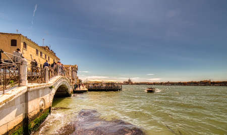 VENEZIA, ITALY â MAY 31, 2019: tourists visiting the city and enjoying the view of  boats passing in sea from  Fondamenta delle Zattereのeditorial素材