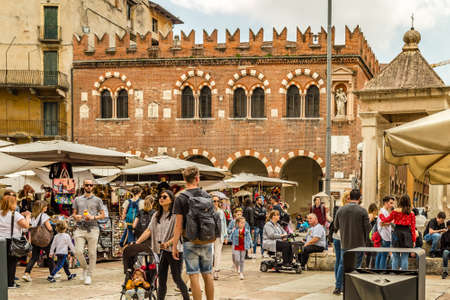 VERONA (VR), ITALY - MAY 10, 2019: tourists visiting the famous Piazzale delle Erbe, Herbs Square, and its typical market in Veronaのeditorial素材