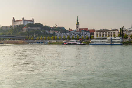 BRATISLAVA, SLOVAKIA - AUGUST 27, 2019: sunlight is enlightening SNP bridge on Danube river flowing along Bratislava, capital of Slovakiaのeditorial素材