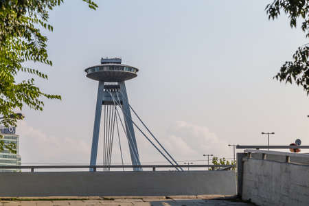 BRATISLAVA, SLOVAKIA - AUGUST 27, 2019: sunlight is enlightening SNP bridge on Danube river flowing along Bratislava, capital of Slovakiaのeditorial素材