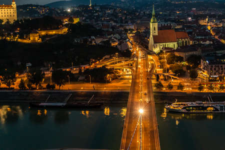 BRATISLAVA, SLOVAKIA - AUGUST 26, 2019: cars passing on SNP bridge on Danube river flowing along Bratislava, capital of Slovakiaのeditorial素材