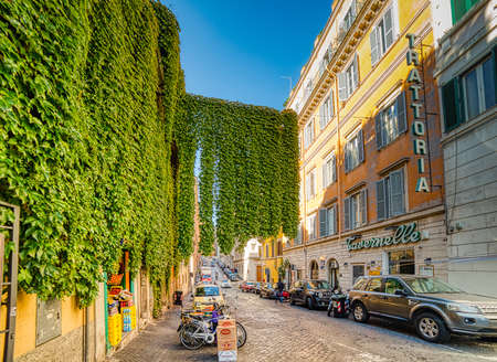 ROME, ITALY - OCTOBER 18, 2019: sunlight is enlightening cars in street of Romeのeditorial素材