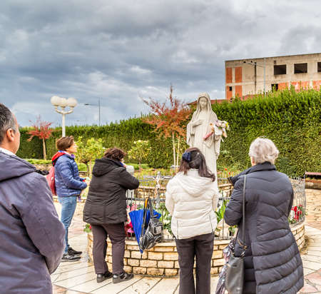 MEDUGORJE, BOSNIA AND HERZEGOVINA - NOVEMBER 3, 2019: pilgrims are praying the statue of The Blessd Virgin Maryのeditorial素材