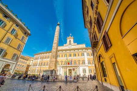 ROME, ITALY - OCTOBER 18, 2019: tourists are visiting Monte Citorio Obelisk in Romeのeditorial素材