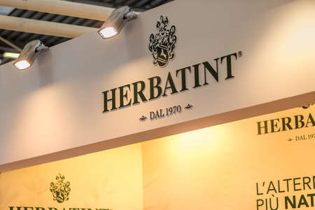 BOLOGNA, ITALY - APRIL 12, 2019: light is enlightening HERBATINT logo in Cosmofarma Exhibition, the pharmacy worldâs leading European event for the Health Care and Beauty Care sectors and all pharmacy-related servicesのeditorial素材