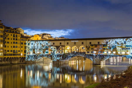 FLORENCE, ITALY - DECEMBER 15, 2019: Christmas projections dedicated to the moon enlightening the Ponte Vecchio, the Old Bridge of Florence on the Arno River in Tuscany in Italy during Firenze Light Festivalのeditorial素材