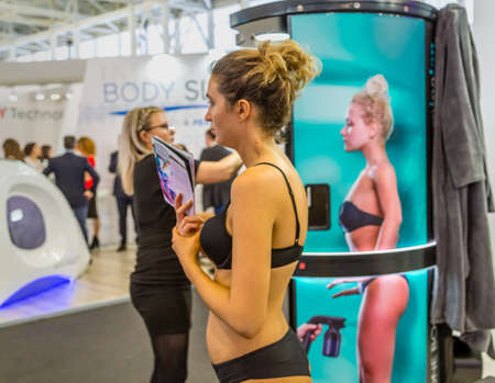 BOLOGNA (BO), ITALY - MARCH 18, 2019: exhibitor is waiting for visitors at COSMOPROF, trade show of the beauty industryのeditorial素材