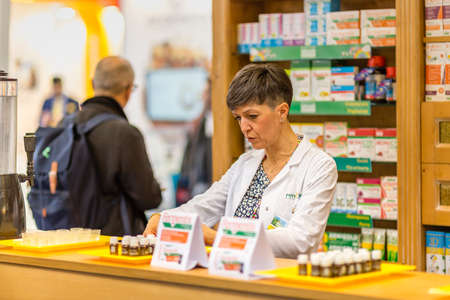 BOLOGNA (BO), ITALY - APRIL 12, 2019: exhibitor is waiting for visitors at Cosmofarma Exhibition, the pharmacy worldâs leading Europeanのeditorial素材