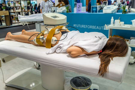 BOLOGNA (BO), ITALY - MARCH 18, 2019: exhibitor is waiting for visitors at COSMOPROF, trade show of the beauty industryのeditorial素材