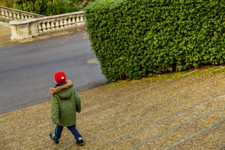 kid walking down ancient stairsの写真素材