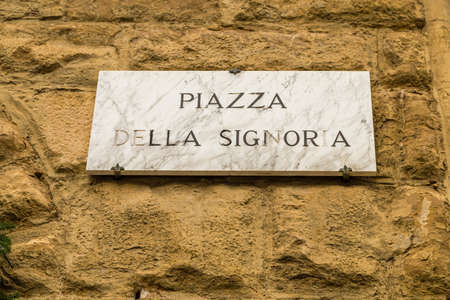 sunlight enlightening street sign in SIgnoria Square in Florence  in Tuscany, Italyの写真素材