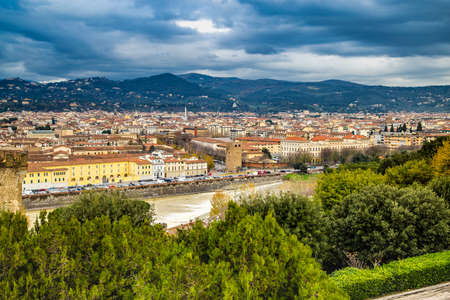 FLORENCE, ITALY - DECEMBER 15, 2019: river running through the buildings of Florence in Tuscany, Italyの写真素材