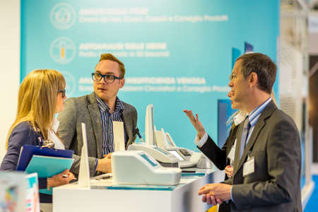 BOLOGNA (BO), ITALY - APRIL 12, 2019: exhibitor are welcoming visitor at Cosmofarma Exhibition, the pharmacy worldâs leading Europeanのeditorial素材