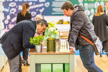 BOLOGNA (BO), ITALY - APRIL 12, 2019: exhibitor is welcoming visitor at Cosmofarma Exhibition, the pharmacy worldâs leading Europeanのeditorial素材