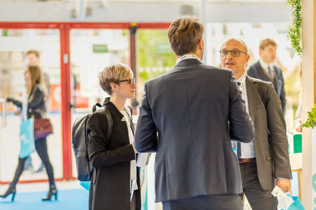 BOLOGNA (BO), ITALY - APRIL 12, 2019: exhibitor is welcoming visitor at Cosmofarma Exhibition, the...