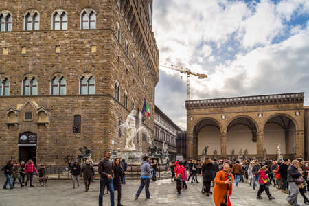 FLORENCE, ITALY - DECEMBER 15, 2019: tourists visiting Palazzo Vecchio in SIgnoria Square in Florence  in Tuscany, Italyのeditorial素材