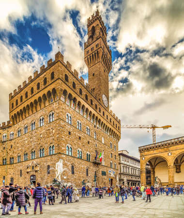 FLORENCE, ITALY - DECEMBER 15, 2019: tourists visiting Palazzo Vecchio in SIgnoria Square in Florence  in Tuscany, Italyのeditorial素材