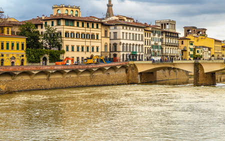 FLORENCE, ITALY - DECEMBER 15, 2019: tourists walking on Ponte Alle Grazie bridge in Florence in Tuscany, Italyのeditorial素材