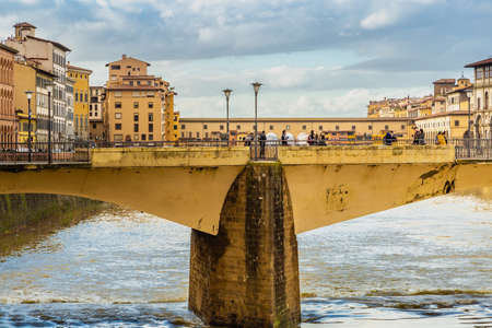 FLORENCE, ITALY - DECEMBER 15, 2019: tourists walking on Ponte Alle Grazie bridge in Florence in Tuscany, Italyのeditorial素材