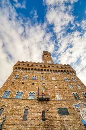 FLORENCE, ITALY - DECEMBER 15, 2019: sunlight enlightening Palazzo Vecchio in SIgnoria Square in Florence  in Tuscany, Italyのeditorial素材