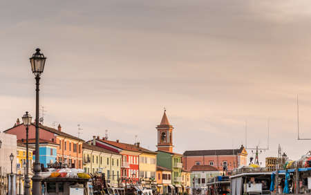 CESENATICO (FC), ITALY - APRIL 1, 2019: sunset is enlightening the buildings and the boats in the Leonardesque port of Cesenatico in Italyのeditorial素材