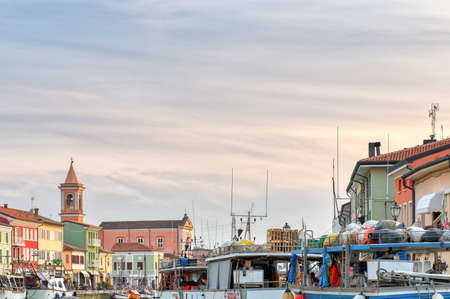 CESENATICO (FC), ITALY - APRIL 1, 2019: sunset is enlightening the buildings and the boats in the Leonardesque port of Cesenatico in Italyのeditorial素材