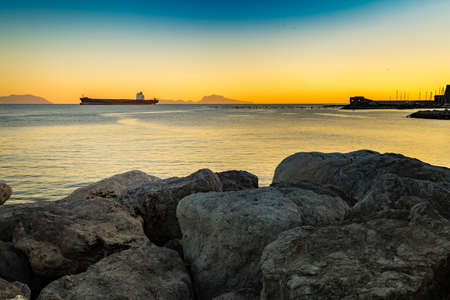 rocks overlooking the boats in the Gulf of Naplesの写真素材