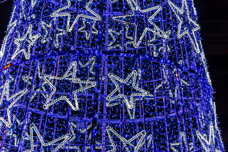christmas lights on arranged in wired mesh on dark backgroundの写真素材