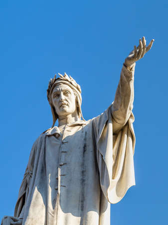 light is enlightening the statue of Dante Alighieri in Naples, Italyの写真素材
