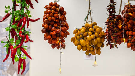 red , orange and yellow chillies hangingの写真素材