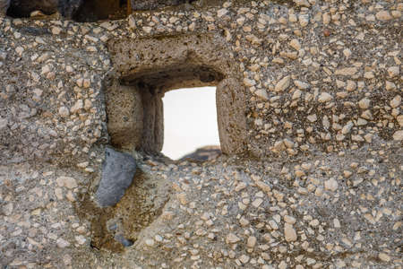 closeup of window in rough sea rock