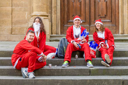 FLORENCE, ITALY - DECEMBER 15, 2019: Santa Claus guys smiling in Florence in Italyのeditorial素材