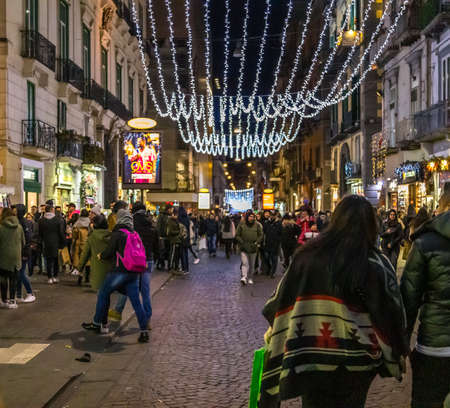 NAPLES, ITALY - JANUARY 5, 2020: tourists are visiting the street of the historical centerの写真素材