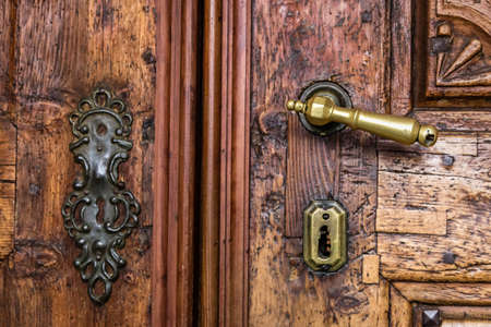 ancient wooden door with handle and lockの写真素材