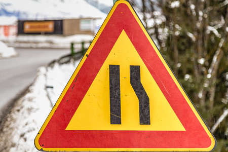 Triangle road sign warning of narrow road