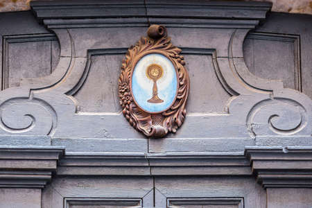 RAVENNA, ITALY - MAY 2, 2019: light is enlightening ancient wooden door of Catholic Church