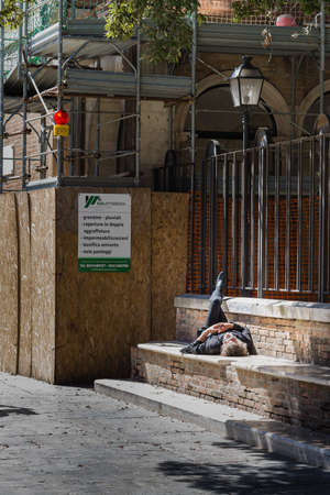 RAVENNA, ITALY - MAY 2, 2019: man resting on back on stepsのeditorial素材