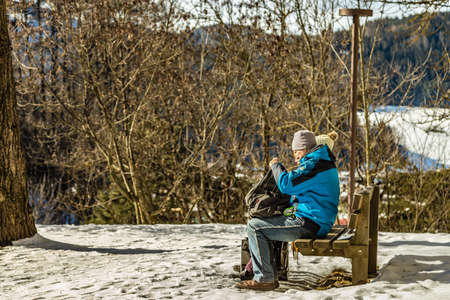 Brunico (BZ), February 12, 2019: tourists resting and sitting on bench in the natureのeditorial素材