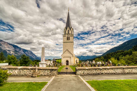 Feistritz an der Gail (VL), Osterreich,  - AUGUST 14, 2019: clouds are covering the sky over the Parish Church dedicated to Saint Martinのeditorial素材