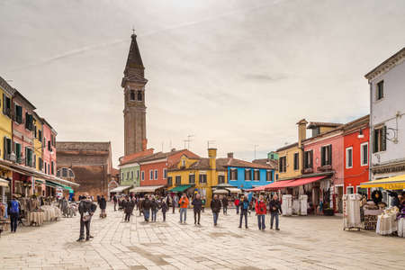 BURANO (VE), ITALY - FEBRUARY 21, 2020: tourists walking in the typical square of Burano, ancient fishing village during Carnivalのeditorial素材