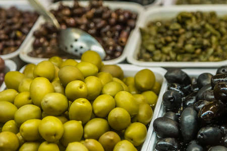 closeup of fresh olives in Italian shopの写真素材