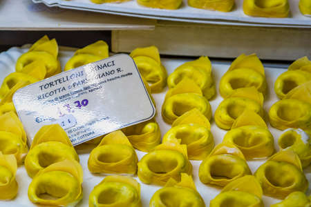 MODENA (MO), ITALY - FEBRUARY 15, 2019: light enlightening handmade tortellon for sale in Albinelli covered market in the historical center of Modenaのeditorial素材