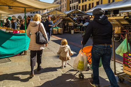 PADOVA, ITALY - FEBRUARY 23, 2019: people going for shopping in typical market in Piazza delle Erbe