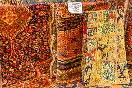 CESENA (FC) - FEBRUARY 16, 2020: lights are enlightening carpets for sale on stalls at antiques fair