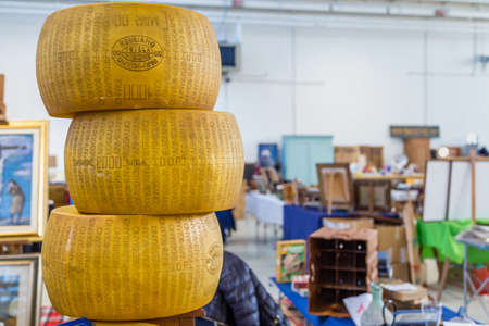 CESENA (FC) - FEBRUARY 17, 2019: lights are enlightening wheels of Parmigiano Reggiano cheese for...