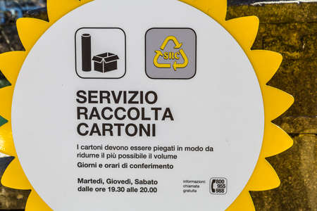 PADOVA, ITALY - FEBRUARY 23, 2019: sunlight is enlightening cardboard and paper collection service...