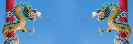 Twin Chinese Dragon statue on blue sky background の写真素材