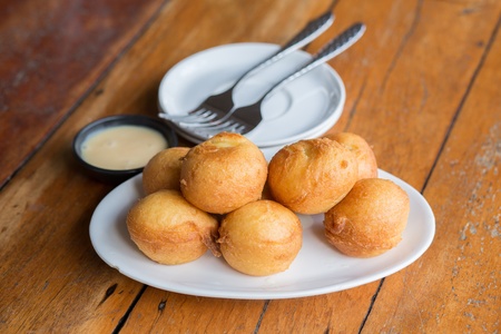 Delicious banana fritters serve with Sweetened condensed milk