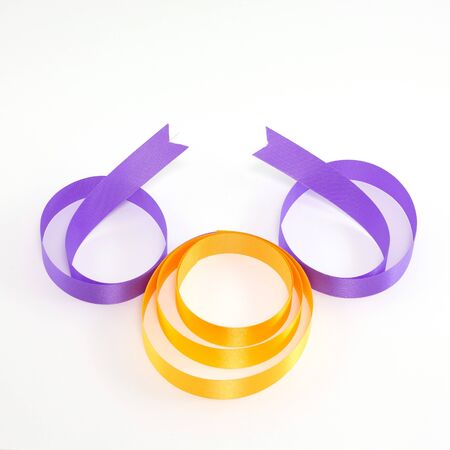 Purple and yellow gift bow isolated on white backgroundの写真素材