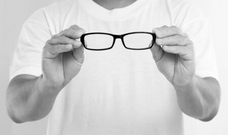 Man hands holding eyeglassesの写真素材